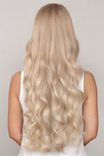 Long wavy hair showcasing the Extra Piece Medium Ash Blonde 24A hair extension for a seamless natural look
