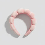 The GRWM Headband in soft pink with padded, textured cushioning for a stylish and comfortable hair accessory.