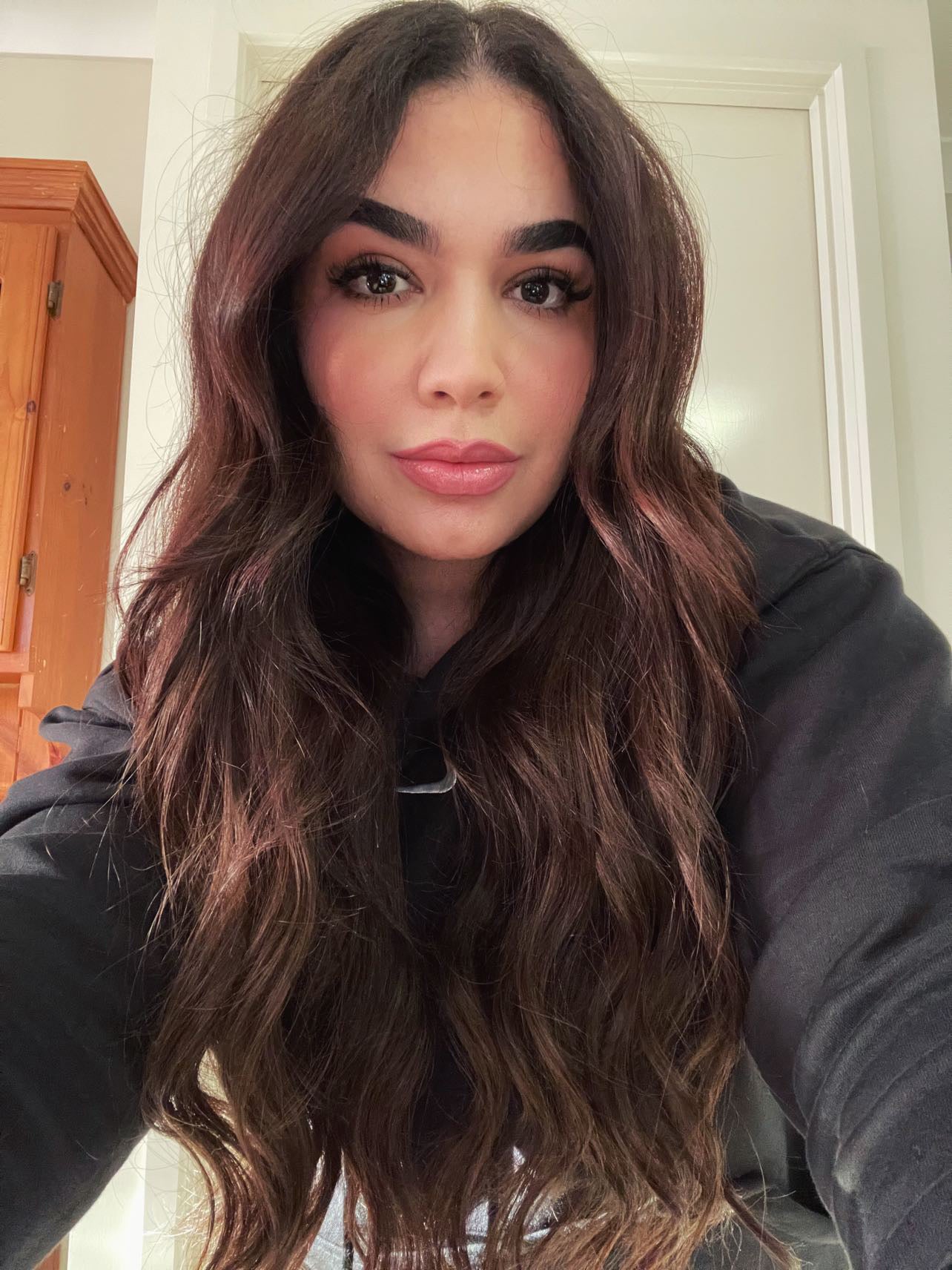 Woman with long wavy hair showcasing the rich tones of Sample Swatch - Dark brown 