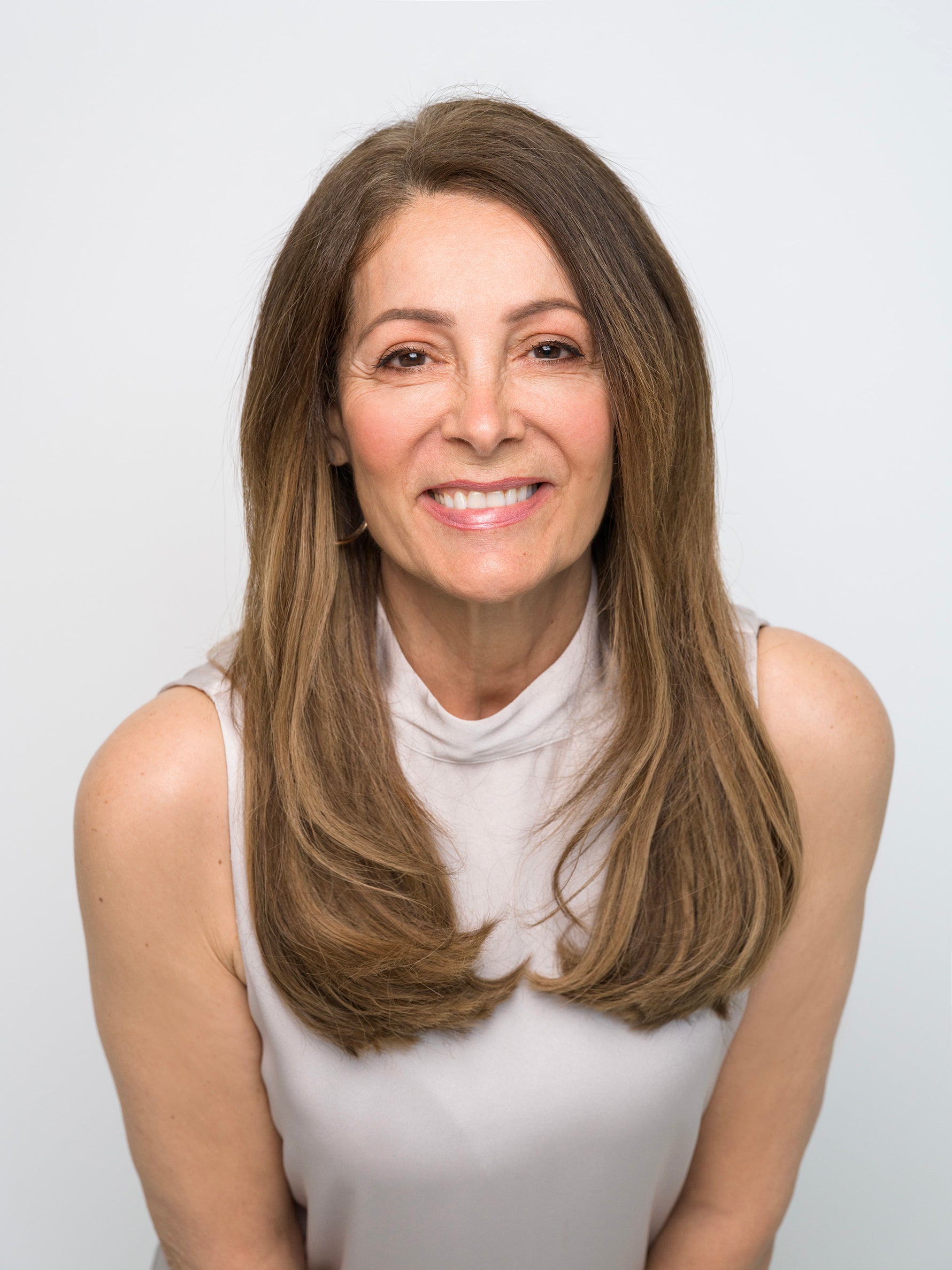 Woman with smooth layered brown hair smiling, showcasing natural look of Extra Hair Extension Piece - 