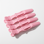 No-Slip Alligator Clips in soft pink with textured grips, designed for secure hold during styling or extensions.