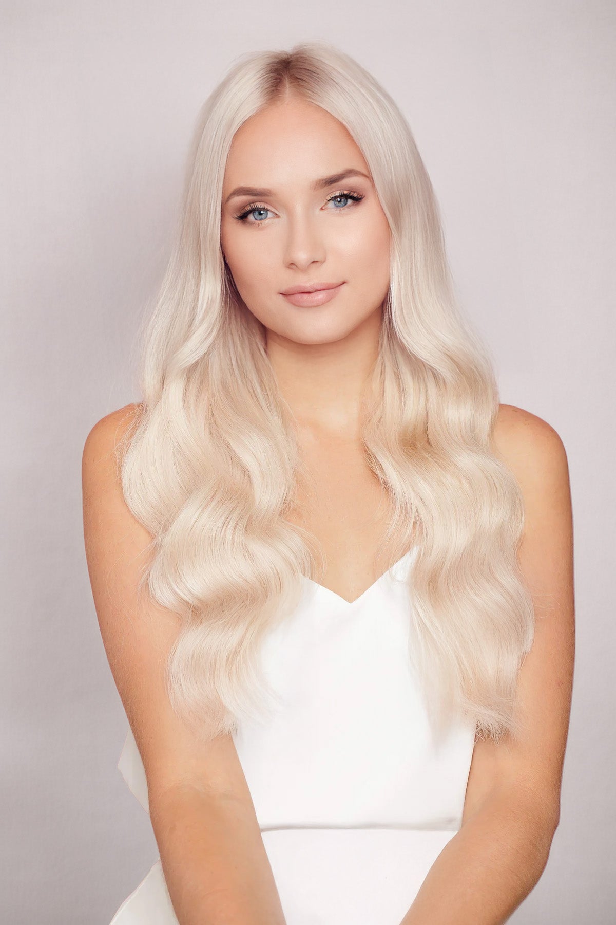 Woman with long wavy pearl blonde hair showcasing Pearl Blonde 